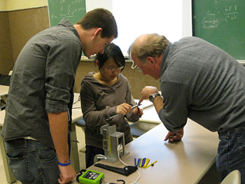 Students (from left) Sean Brennan and Celia Gong, in class with Chrzan, use popsicle sticks and a three-point bending apparatus to study the modulus of rupture, a measurement of the load required to break a skateboard. PHOTO CREDIT: ABBY COHN