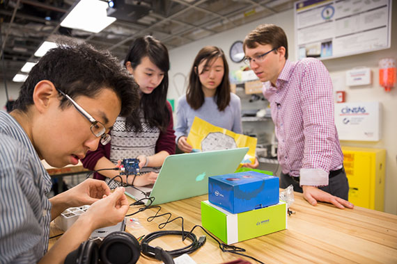 Björn Hartmann (right) working with students in the Invention Lab. Photo by Matt Beardsley.