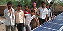 Indian villagers with solar power array