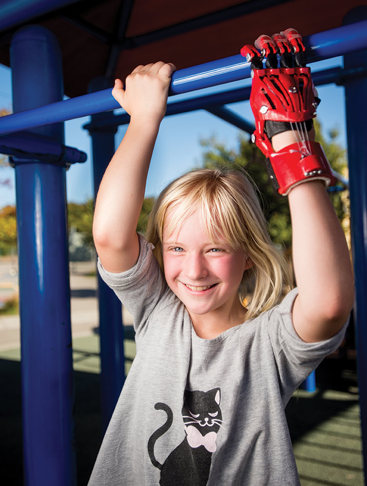 Sophie climbing with her 3D-printed prosthetic hand