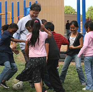 As part of his inaugural listening tour throughout the San Joaquin Valley (April 2007), Chancellor Kang enjoyed a pick-up game of soccer with students at Alicia Reyes Elementary School in Merced. Photo courtesy of UC Merced.