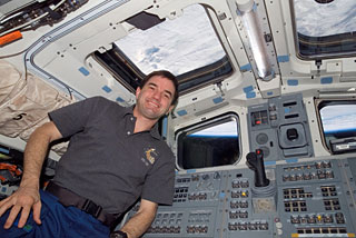 Rex Walheim by the shuttle window. Photo courtesy of NASA 