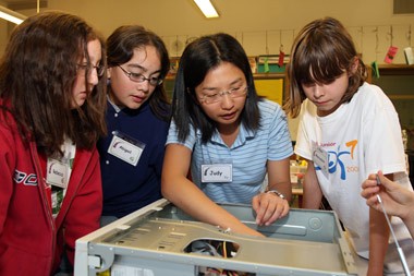 Berkeley Engineering alumna Judy Lau (B.S.'00 EECS, second from right) guides three students from Oakland's Montera Middle School in dissecting a computer during an after-school program sponsored by Techbridge, a program of Chabot Space and Science Center that introduces girls to technology, science and engineering. Photo credit: Eric Weisz 