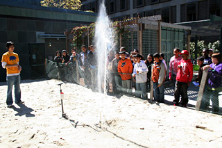 LIFTOFF! A volunteer with Berkeley Engineers and Mentors (BEAM), left, launches a water bottle rocket as part of a lesson for local elementary school children in force, thrust and drag. PHOTO COURTESY BEAM