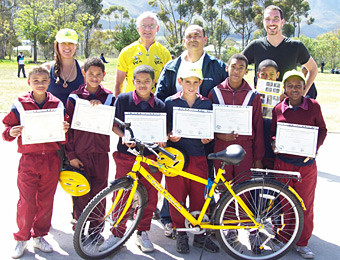 CYCLING ADVOCATE: Louis de Waal (in yellow) and other BEN staffers with children who had just completed their bicycle safety course. De Waal cofounded BEN, the Bicycling Empowerment Network, in 2002 to improve mobility and alleviate poverty in South Africa. Courtesy Louis de Waal