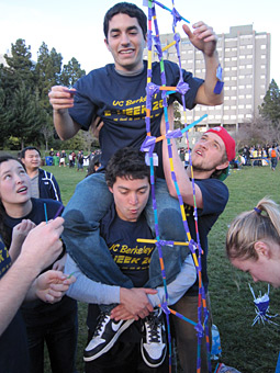 GETTING A LIFT: Bolstered by engineering know-how and solid teamwork, the mechanical engineering team works diligently to build a soaring tower of popsicle sticks. ABBY COHN