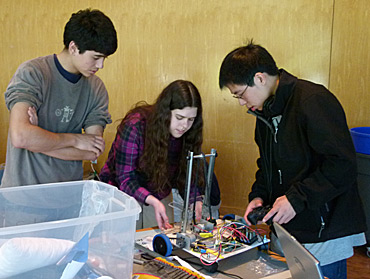 TEAM-DRIVEN: Local high school engineers work together to construct a robot for the Pioneers in Engineering competition. Twelve teams participated in this year’s program, which aims to create an affordable introduction to engineering for local high school students. HAMILTON NGUYEN