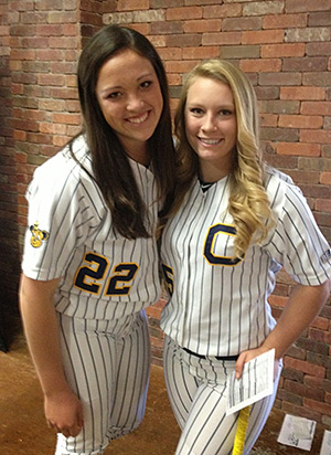 Breana Kostreba and Mary Lee in their softball uniforms