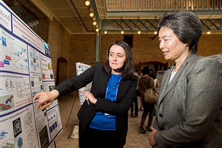 Tsu-Jae King Liu with student at poster session in Hearst Mining atrium