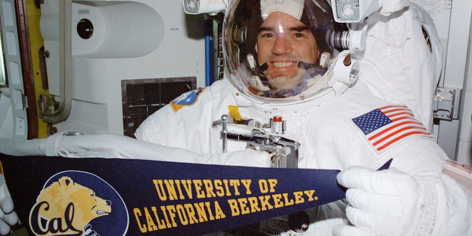 Astronaut Rex Walheim with a Berkeley pennant