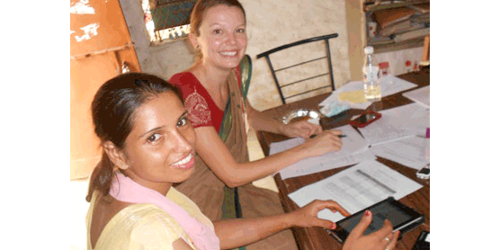Emmunify team member Jessica Watterson in New Delhi with an outreach worker to conduct a usability test. 