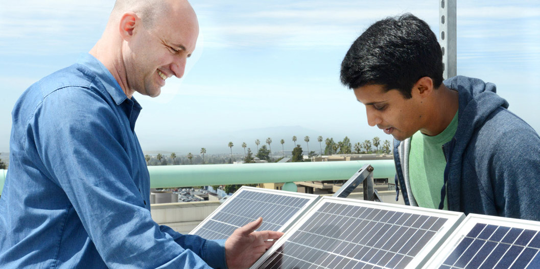 Eric Brewer and graduate student Achintya Maduri inspect solar panels