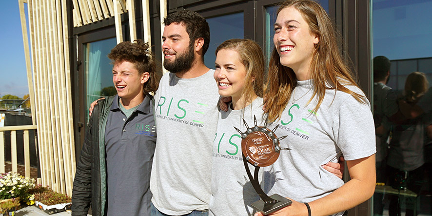 UC Berkeley graduates Brenton Kreiger and Sam Durkin stand with seniors Ruth McGee and Joan Gibbons after their solar house won third place. 