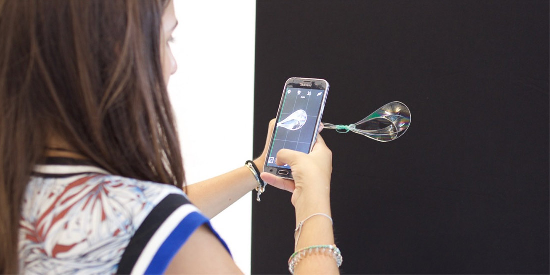 A student uses wires, soap and a handheld device to explore bending effects
