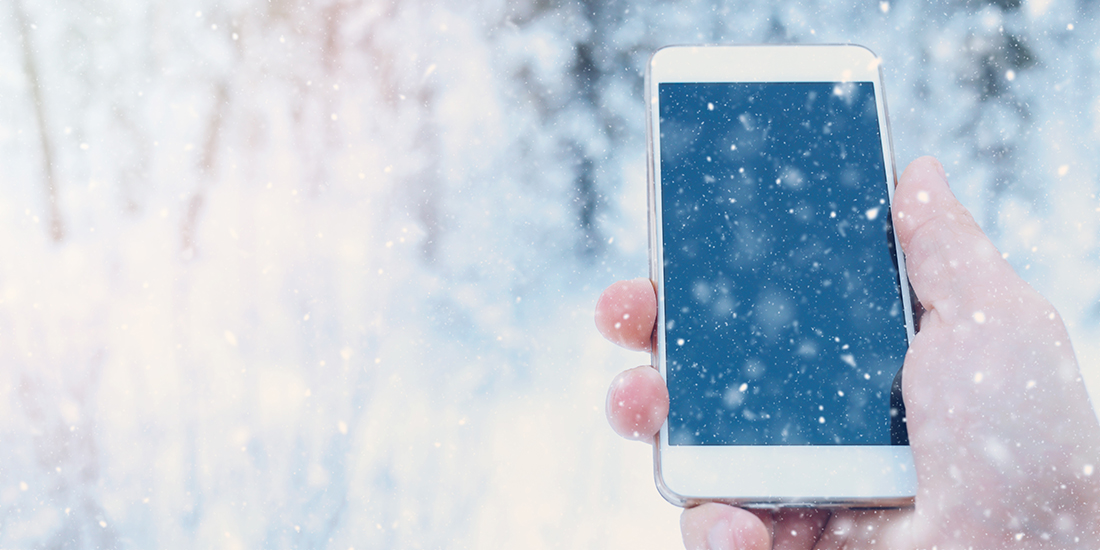 Smartphone in hand in winter