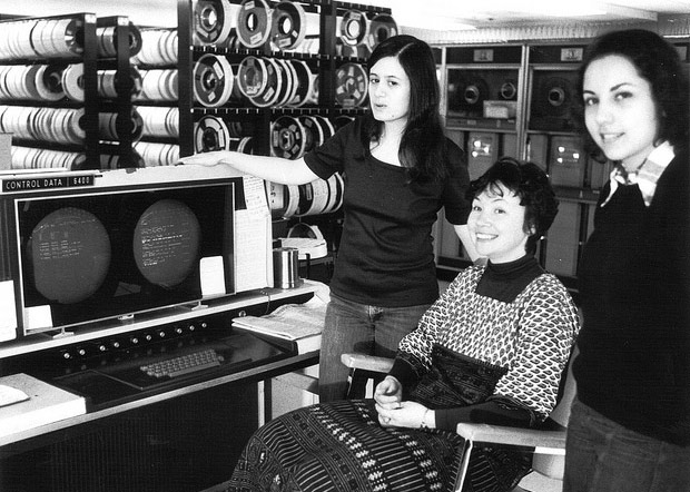 Women by a computer monitor and tape drives
