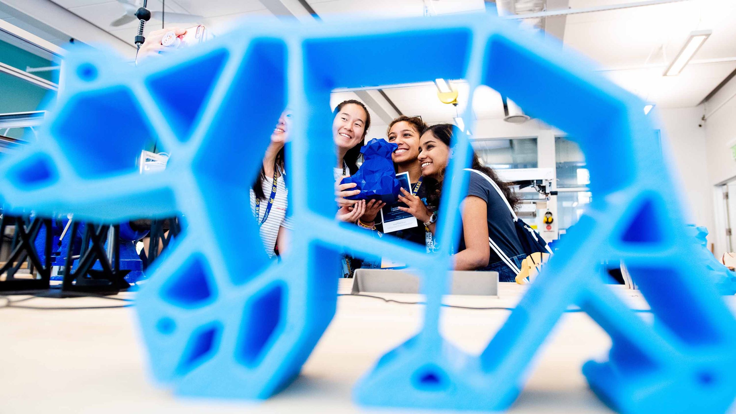 Students with 3-D printed blue bear