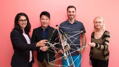 Students and faculty with tensegrity robot