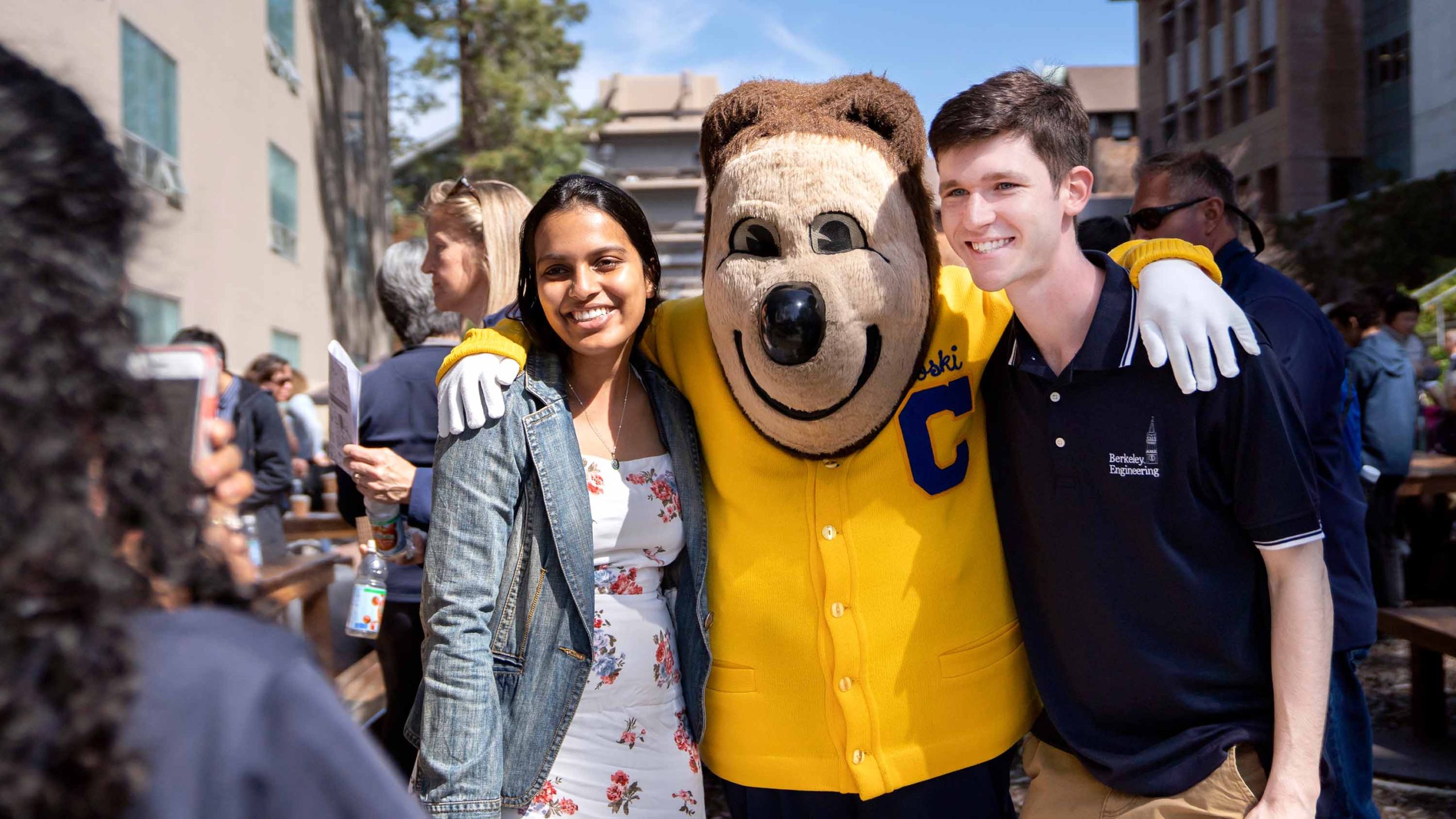 Oski posing for photos with students