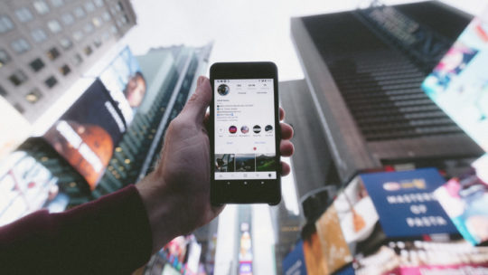 Smartphone with tall buildings in the background