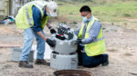 UC Berkeley workers remove a wastewater autosampler from a sewer drain