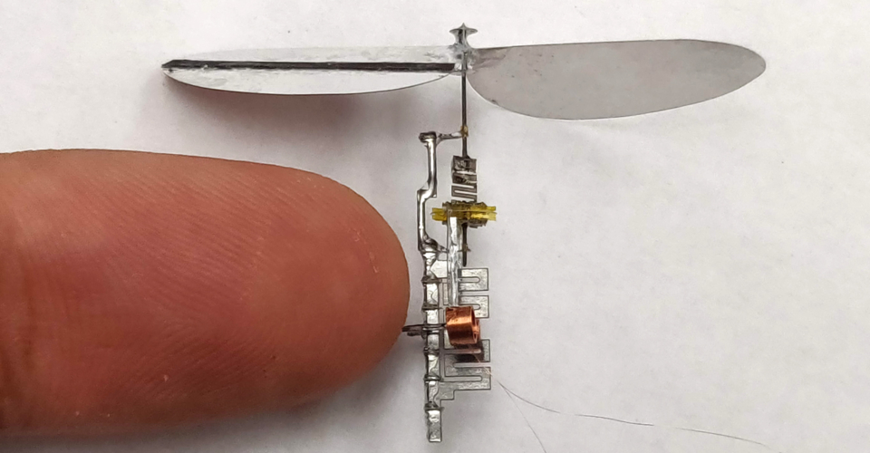 SpiE Spinning Engine next to a finger for size comparison