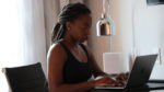 EECS graduate student Gloria Tumushabe using a laptop