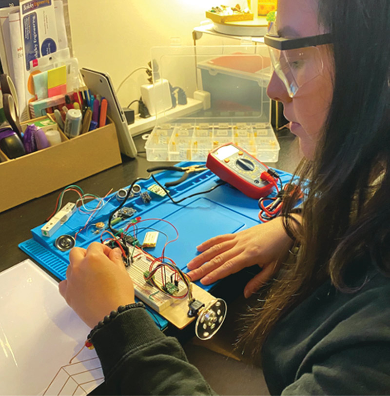 Undergrad student Natalia Perez working on electronics project at home
