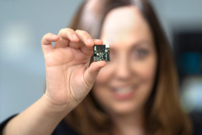 EECS professor Rikky Muller holding a WAND mini pacemaker for the brain