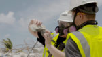 NIST staff members examine pieces of concrete removed from the debris pile