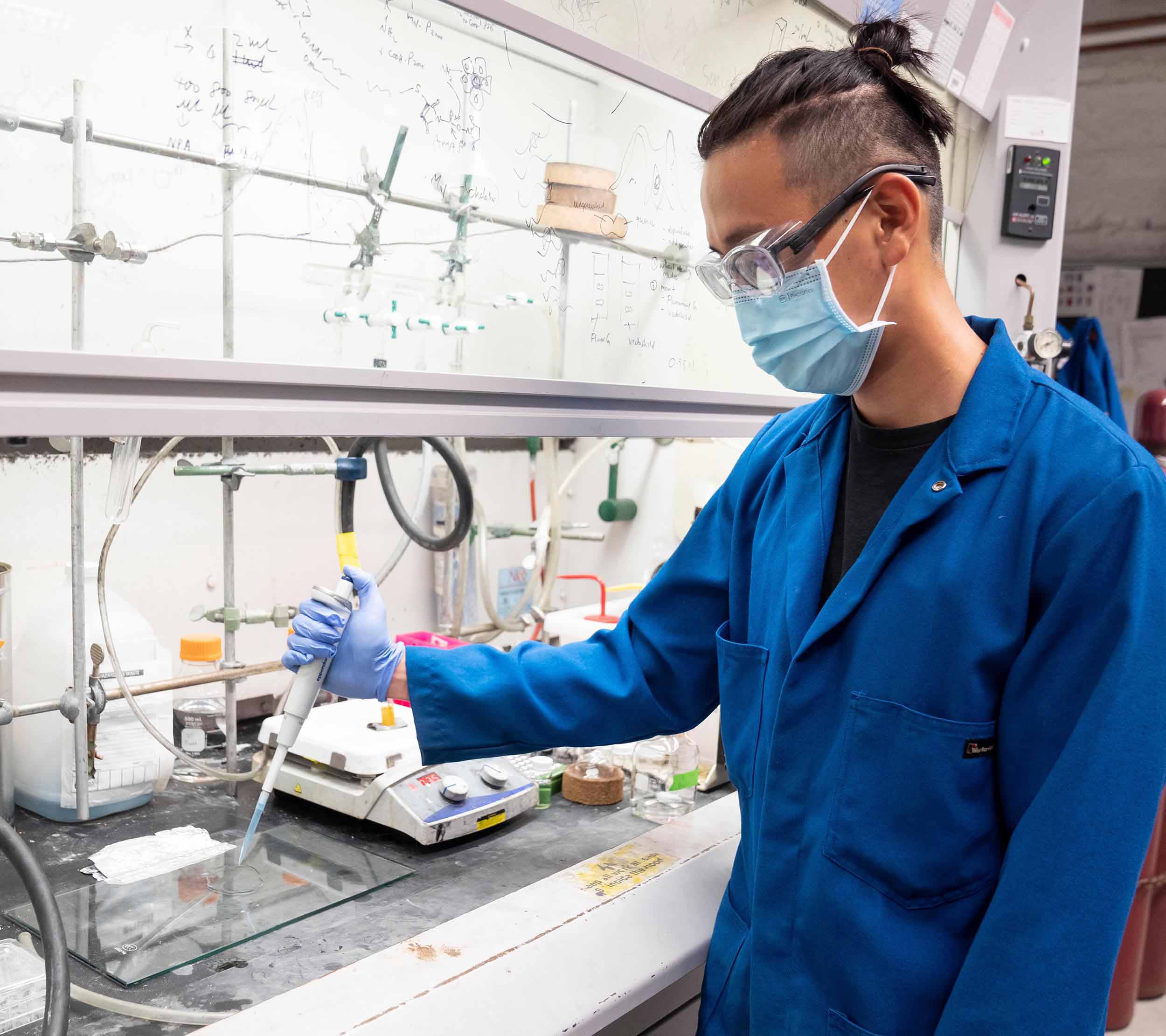 Graduate student Ivan Jayapurna prepares a sample film of polylactic acid plastic