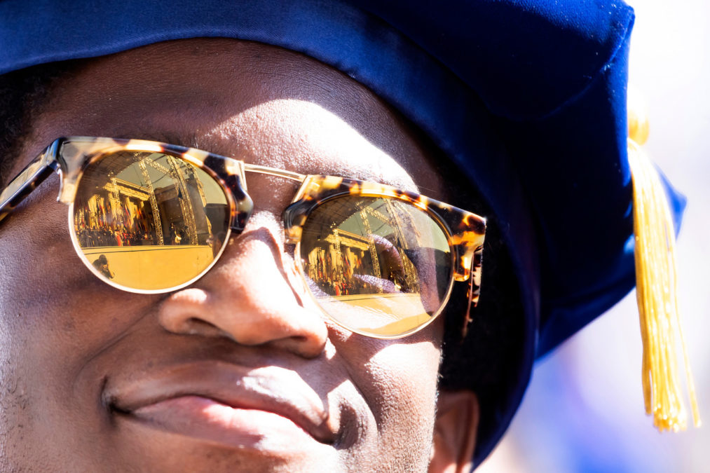The Greek Theatre is reflected in a graduate's sunglasses
