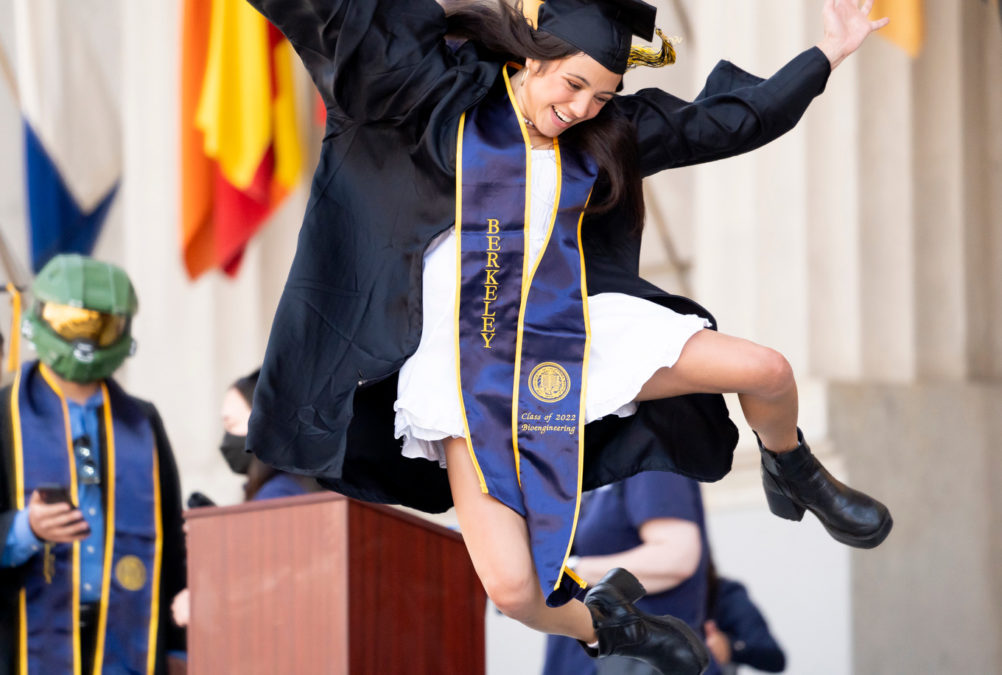 Graduates leaps across stage in the Greek Theatre