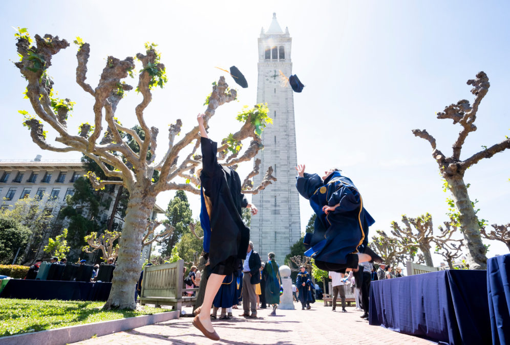 Graduates jump beneath the Campanile