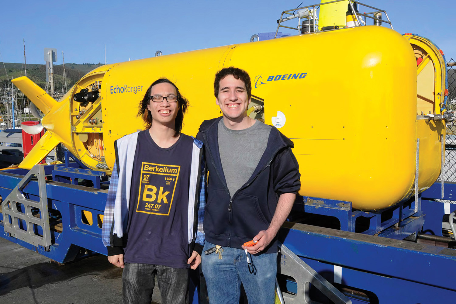 Nuclear engineering alum and student pose in front of submersible used to find the sunken USS Independence