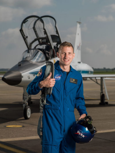 Warren Hoburg in flight suit in front of jet