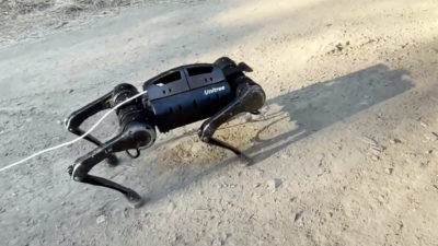 A quadruped robot navigates uphill terrain