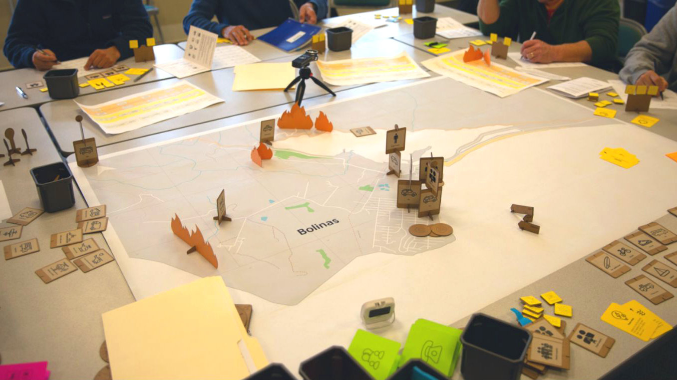 Community members from Bolinas, California, play an evacuation-simulation board game