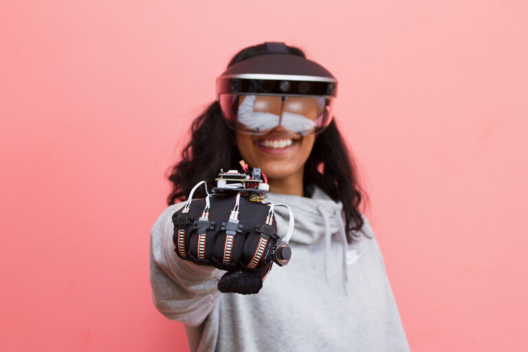 Female student wearing modified glove and goggles at Fung Institute Capstone Showcase