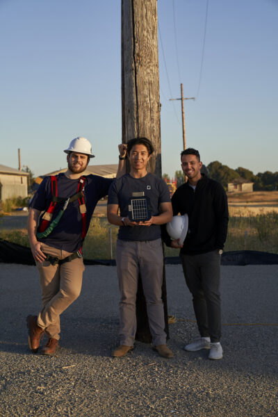 Photo of Gridware's founders holding Gridscope, a device for real-time monitoring of power lines. (Courtesy Gridware)