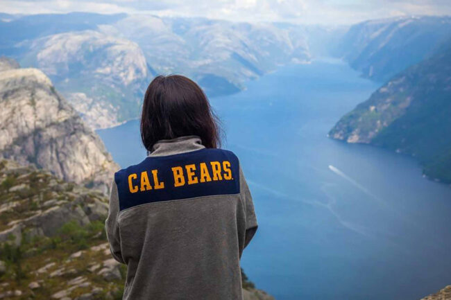 Woman in Cal Bears sweater looking into vista of the Lysefjord in Norway