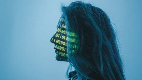 Image of woman with binary code superimposed on her face.