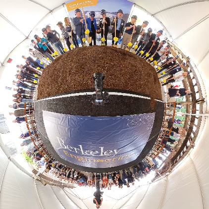 A 360-degree view of the Engineering Center's groundbreaking where the ground is made to look spherical and people with shovels appear to stand on the sphere in a perfect circle.
