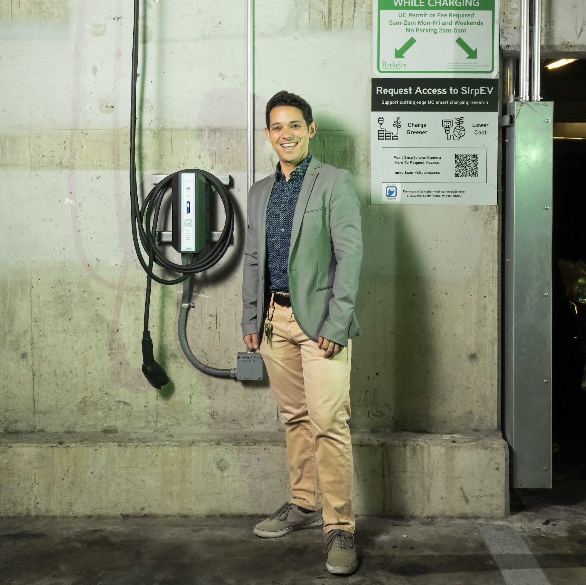 Scott Moura stands in front of a charging station at the RSF garage.