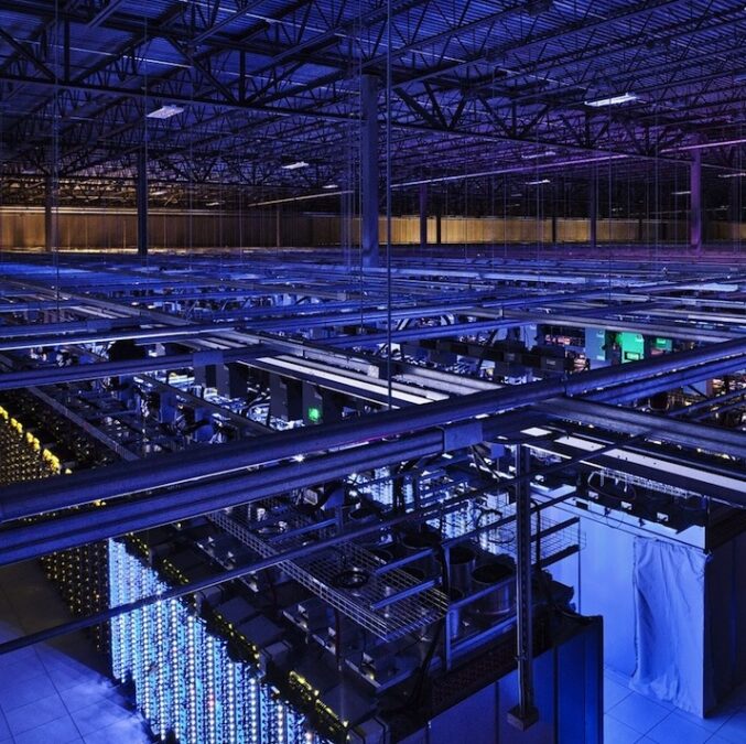 A data center in blue lighting.