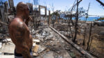 Volunteer surveying homes destroyed by wildfire in Lahaina, Hawaii.
