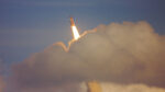 Image of rocket breaking through the clouds.