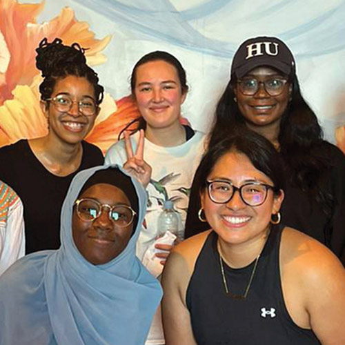 Five female students in front of flowhouse mural