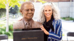 Sculptor Dana King poses with her bust of electrical engineering professor Joseph Gier