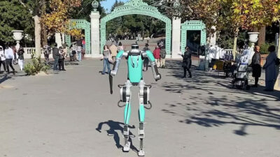 Photo of Berkeley researchers' newly trained, human-sized robot walking out of Sather Gate.